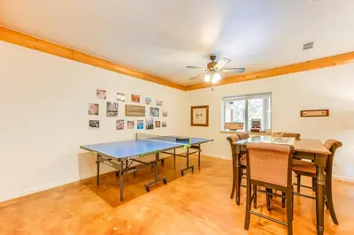a dining room with a ping pong table and chairs at Mountain Cabin with Hot Tub 4 Mi to Shaver Lake! in Shaver Lake