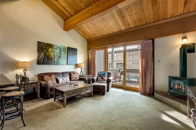 a living room with a couch and a table at Lofted Retreat in The Village! condo in Truckee