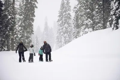 a group of people standing in the snow at Lofted Retreat in The Village! condo in Truckee