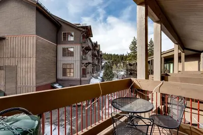 a patio with a table and chairs on a balcony at Lofted Retreat in The Village! condo in Truckee