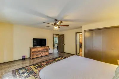 a bedroom with a bed and a flat screen tv at 2 Mi to Mi-Wuk Village Cabin with Large Deck in Twain Harte