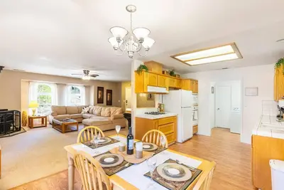 a kitchen and living room with a table and chairs at Riverside Manna in Mariposa