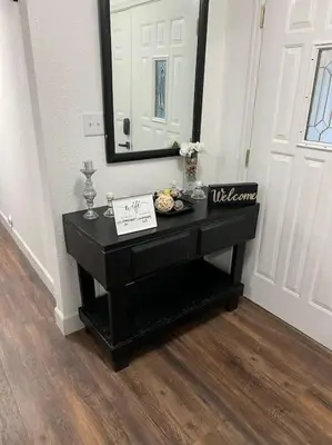 a black console table in a room with a mirror at Sequoia Villa in Visalia