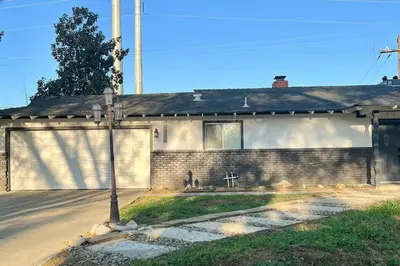 a brick house with a garage and a street at Sequoia Villa in Visalia