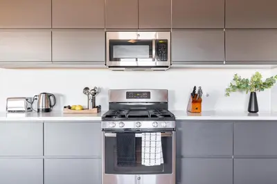 a kitchen with a stove and a microwave at Rolling Oaks Ranch - 200 Acres of Lakeside Beauty & Countryside Serenity in Mariposa