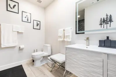 a white bathroom with a toilet and a sink at Rolling Oaks Ranch - 200 Acres of Lakeside Beauty & Countryside Serenity in Mariposa