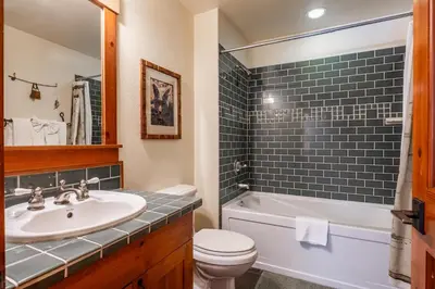 a bathroom with a sink and a toilet and a tub at Cabins 24 in Mammoth Lakes