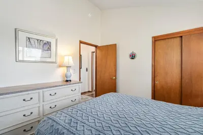 a bedroom with a blue bed and a wooden cabinet at Kathy's Korner - Pet Friendy with Large Deck! home in Groveland
