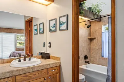 a bathroom with a sink and a tub and a toilet at Kathy's Korner - Pet Friendy with Large Deck! home in Groveland