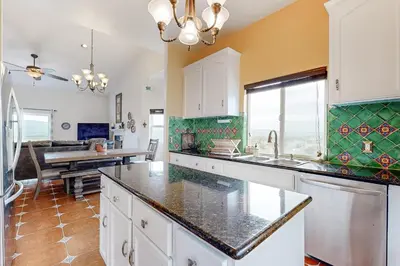 a kitchen with white cabinets and a counter top at Hot Tub and Expansive Views Copperopolis Mtn Home in Copper Cove Subdivision