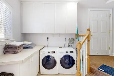 a white laundry room with a washer and dryer at Andria Grove in Stateline