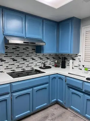 a blue kitchen with a stove and blue cabinets at Entire 3 BR & 2 BA house for business and family in Modesto
