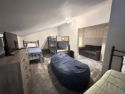 a living room with a bed and a couch at Rustic Modern Condo - Close to Village - Sleeps 10 in Mammoth Lakes