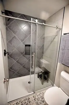 a bathroom with a shower with a toilet at Rustic Modern Condo - Close to Village - Sleeps 10 in Mammoth Lakes