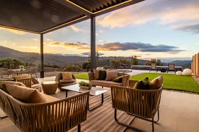 an outdoor patio with furniture and a view of the mountains at Horizon by Yosemite in Midpines