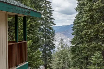 a balcony of a house with a view of the mountains at Lower Cascades in Yosemite West