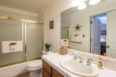a bathroom with a sink and a toilet and a mirror at Lower Cascades in Yosemite West