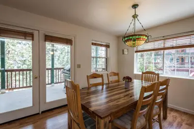 a dining room with a wooden table and chairs at Lower Cascades in Yosemite West