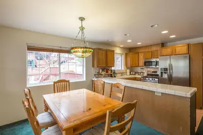 a kitchen with a wooden table and a dining room at Lower Cascades in Yosemite West