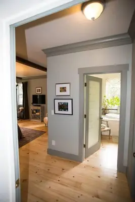 a hallway with a door open to a living room at Yosemite Firehouse Inn in Mariposa