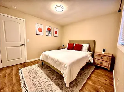 a bedroom with a bed with red pillows and a door at Sunrise View in Rocklin