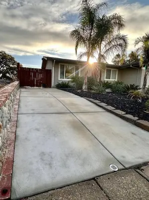 a sidewalk in front of a house with a palm tree at Sunrise View in Rocklin