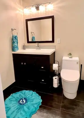 a bathroom with a toilet and a sink and a mirror at Sunrise View in Rocklin