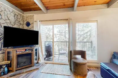 a living room with a flat screen tv and a fireplace at Tahoe Heavenly Hideaway in Stateline