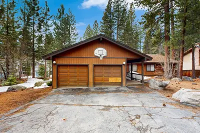 a house with a garage with a basketball hoop at Scenes of Evergreens in Incline Village