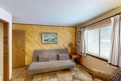 a living room with a couch and a window at Scenes of Evergreens in Incline Village