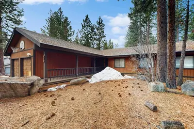 a house with a large yard in front of it at Scenes of Evergreens in Incline Village