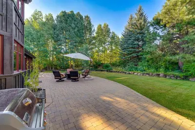 a patio with two chairs and an umbrella at Private Patio and Gas Grill Stunning Truckee Home in Truckee