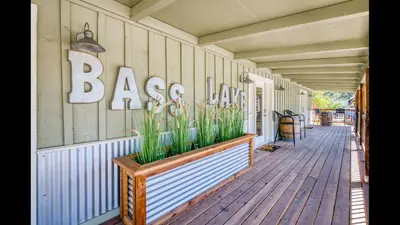 a porch with a planter on the side of a house at #2 Cottage Like Suite With Private Hot Tub in Bass Lake