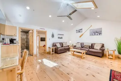 a living room with two couches and a table at #3 Cottage Like Suite With Private Hot Tub in Bass Lake