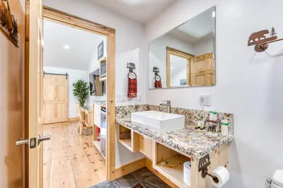 a kitchen with a sink and a counter at #3 Cottage Like Suite With Private Hot Tub in Bass Lake