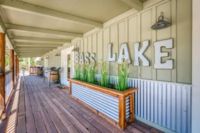 a porch of a house with a sign that reads bass lake at #3 Cottage Like Suite With Private Hot Tub in Bass Lake