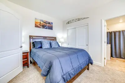 a bedroom with a blue bed in a room at WWII Aviation-Themed Apt in Sparks Near Parks! in Sparks