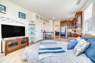 a living room with a large flat screen tv at WWII Aviation-Themed Apt in Sparks Near Parks! in Sparks