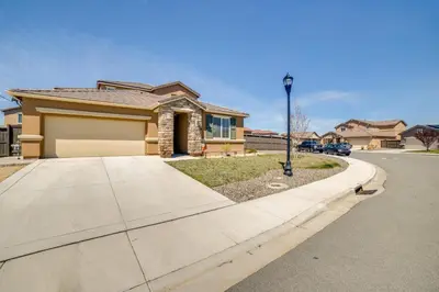 a house on a street with a driveway at WWII Aviation-Themed Apt in Sparks Near Parks! in Sparks