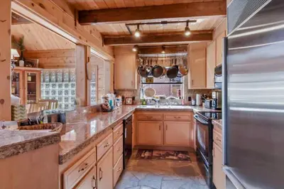 a large kitchen with wooden cabinets and a stainless steel refrigerator at Incline Village Getaway in Incline Village