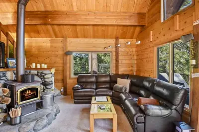 a living room with a leather couch and a fireplace at Incline Village Getaway in Incline Village