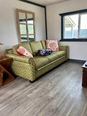 a living room with a couch with pillows on it at Mystic Mountain Retreat in Miramonte