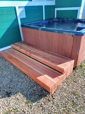 a hot tub sitting outside of a house at Mystic Mountain Retreat in Miramonte