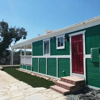 a green and red house with a red door at Mystic Mountain Retreat in Miramonte