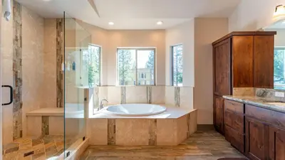 a bathroom with a tub and a shower at 10mins to Lake • Hot Tub Game Room Forest Views Meyers Meadow by AvantStay in South Lake Tahoe
