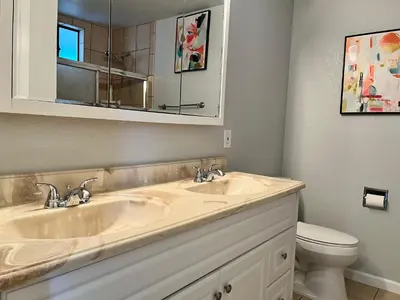 a bathroom with two sinks and a toilet at Cozy Suite with Private Patio Close to Downtown and UC Davis Medical Center in Sacramento