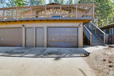 a house with two garage doors and a balcony at 1 Mi to Ski Resort South Lake Tahoe Townhome in South Lake Tahoe