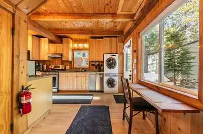 a kitchen with a wooden ceiling and a table with chairs at 3BD Retreat - 5 Min to Beach Trails & Town in Carnelian Bay