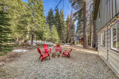 three red chairs and a table outside of a house at 3BD Retreat - 5 Min to Beach Trails & Town in Carnelian Bay