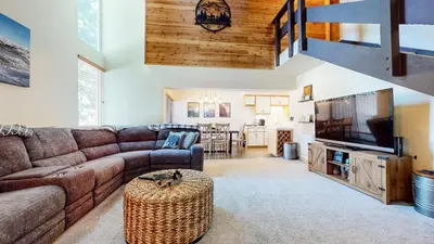 a living room with a couch and a tv at Sierra Park Road #150 condo in Mammoth Lakes